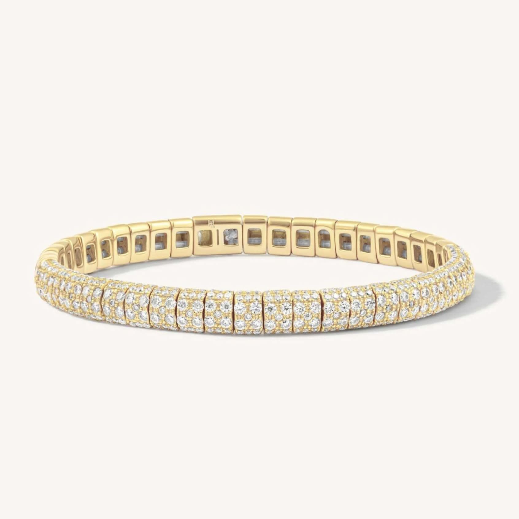 Gold bracelet with diamond accents on a white background